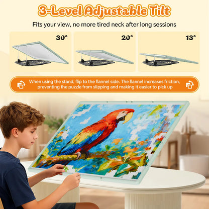 A boy using the green puzzle board with its 3-level adjustable tilt feature at 13, 20, and 30 degrees for ergonomic comfort while puzzling.